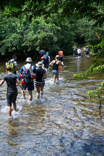 people crossing kee-deep river