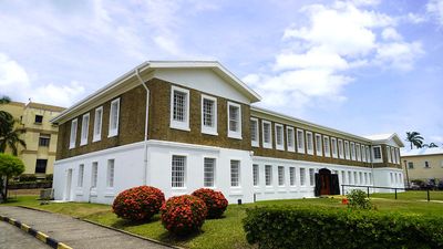 two story building museum with shrubs around it