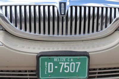 green license plate on old taxi