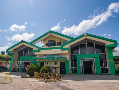 yellow and green building with a bicycle rack in front