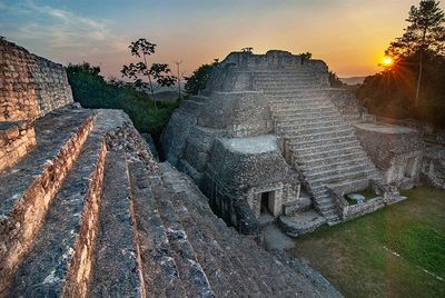 two mayan ruins with sunset in background