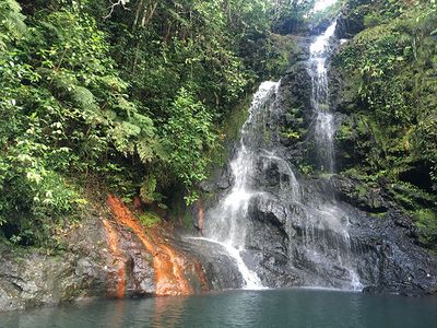 waterfall with red mud on the left