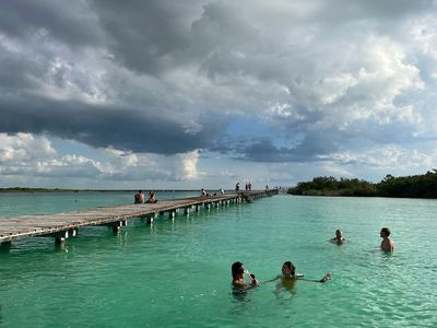 Eco Parque at Bacalar green lagoon with dock and people