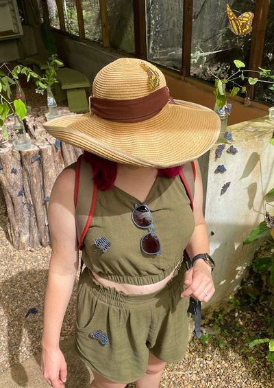 girl with hat with butterflies on her green blouse