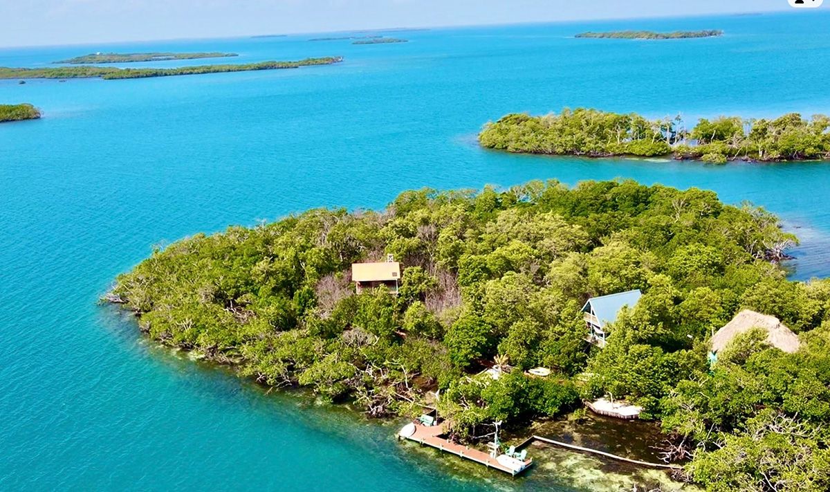wild small island with mangroves and three small houses