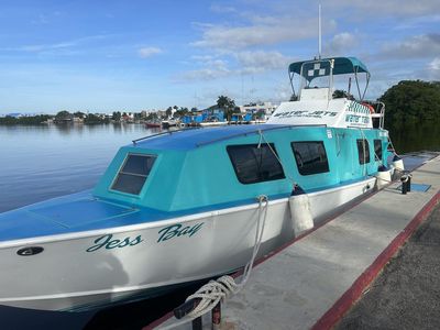 medium sized boat docking close to sunset