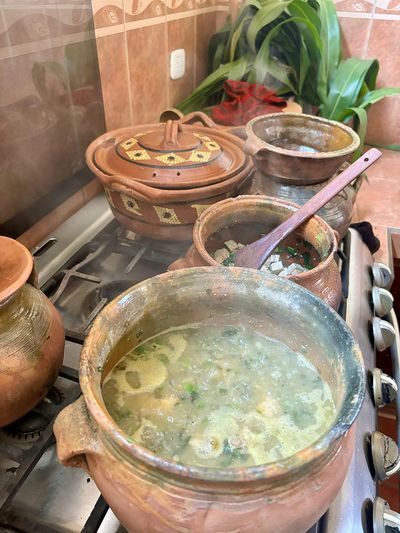 Jocón cooking in traditional Guatemalan pots green stew cooking in traditional pots