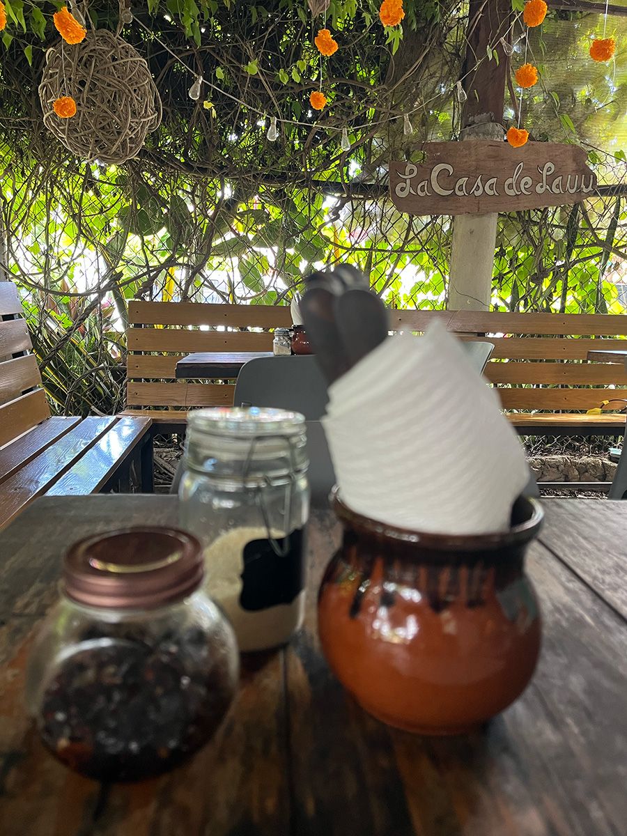 table with condiments at restaurant with sign