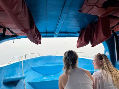 Tourists on a boat/lancha two blonde girls on a small boat
