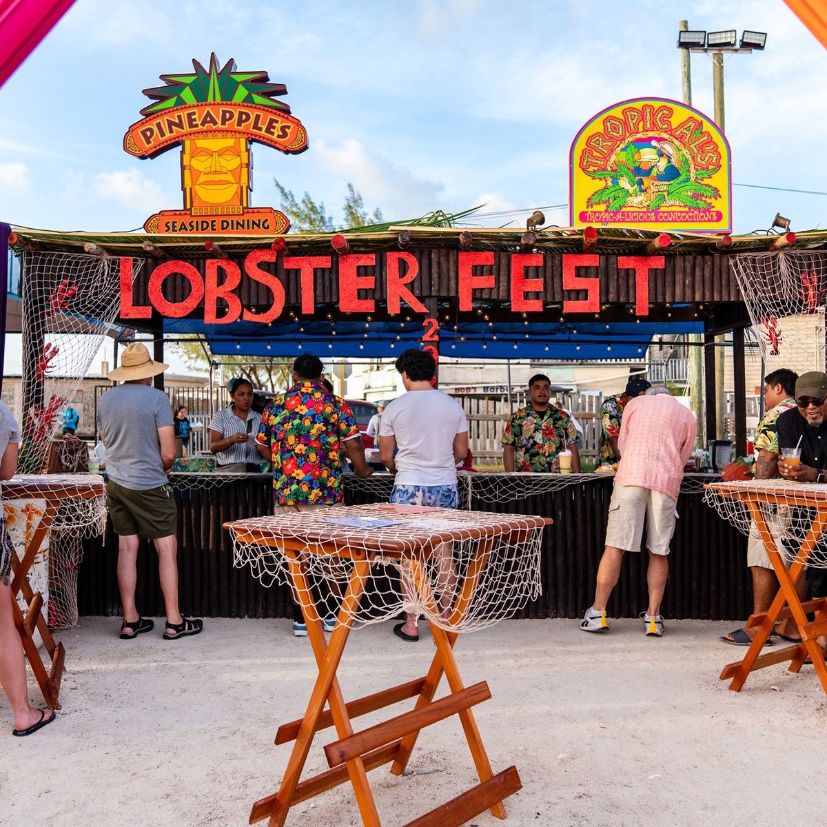 festival stall with tourists and tables in front