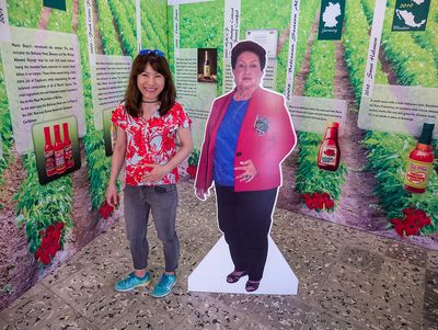 woman standing next to cut-out photo of another woman