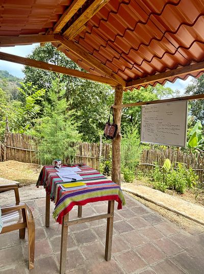 Open-air Maya Magic School classroom outdoor classroom with colorful table cloth and whiteboard