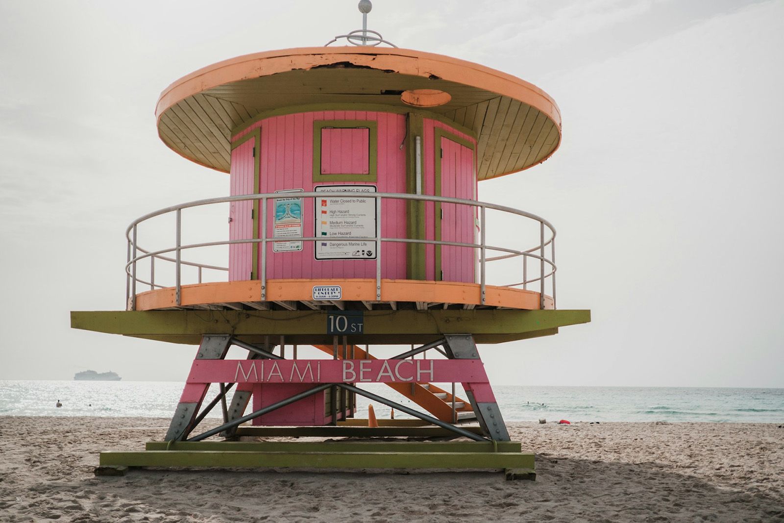 pink and peach colored lifeguard post on a beach