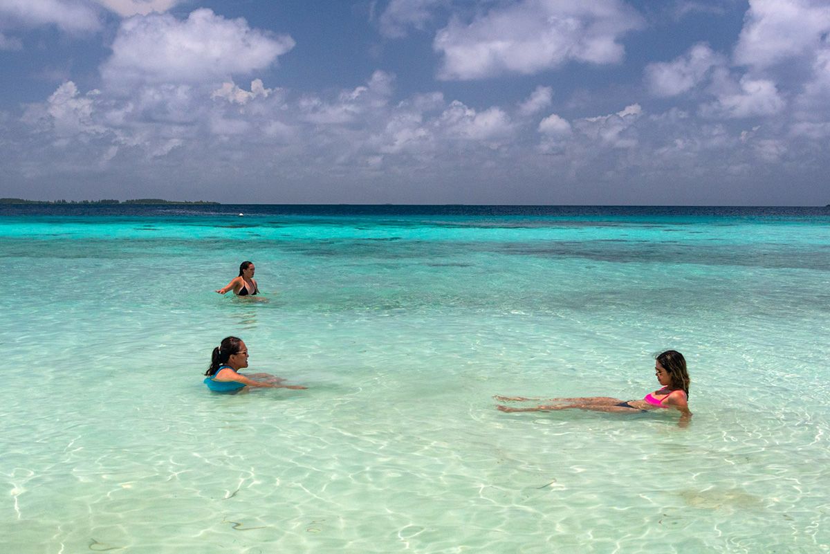 three women in clear water beach