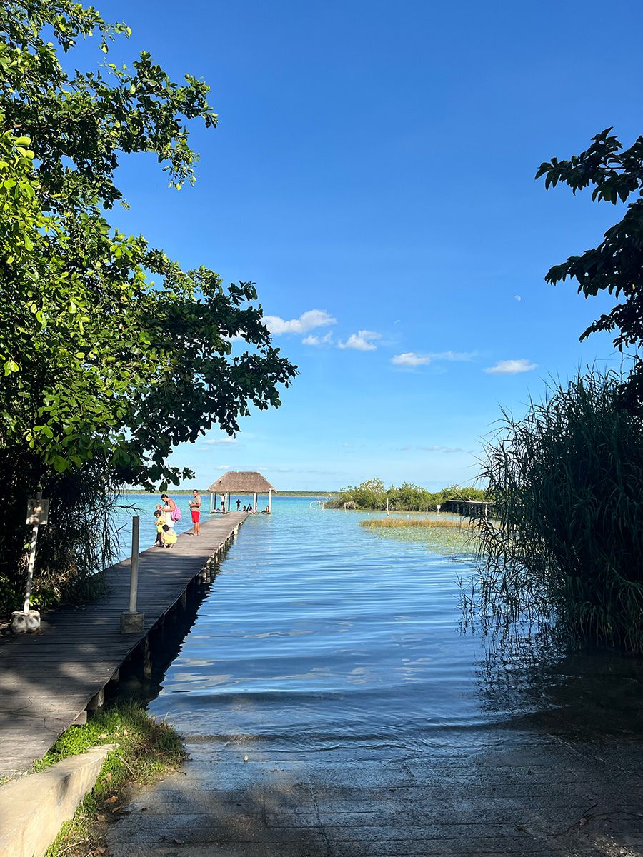 pier with thatch roof and people