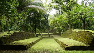mayan ruin ball court with rainforest backdrop