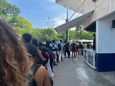 Long line for Playa Express Colectivo large number of people in line for ticket