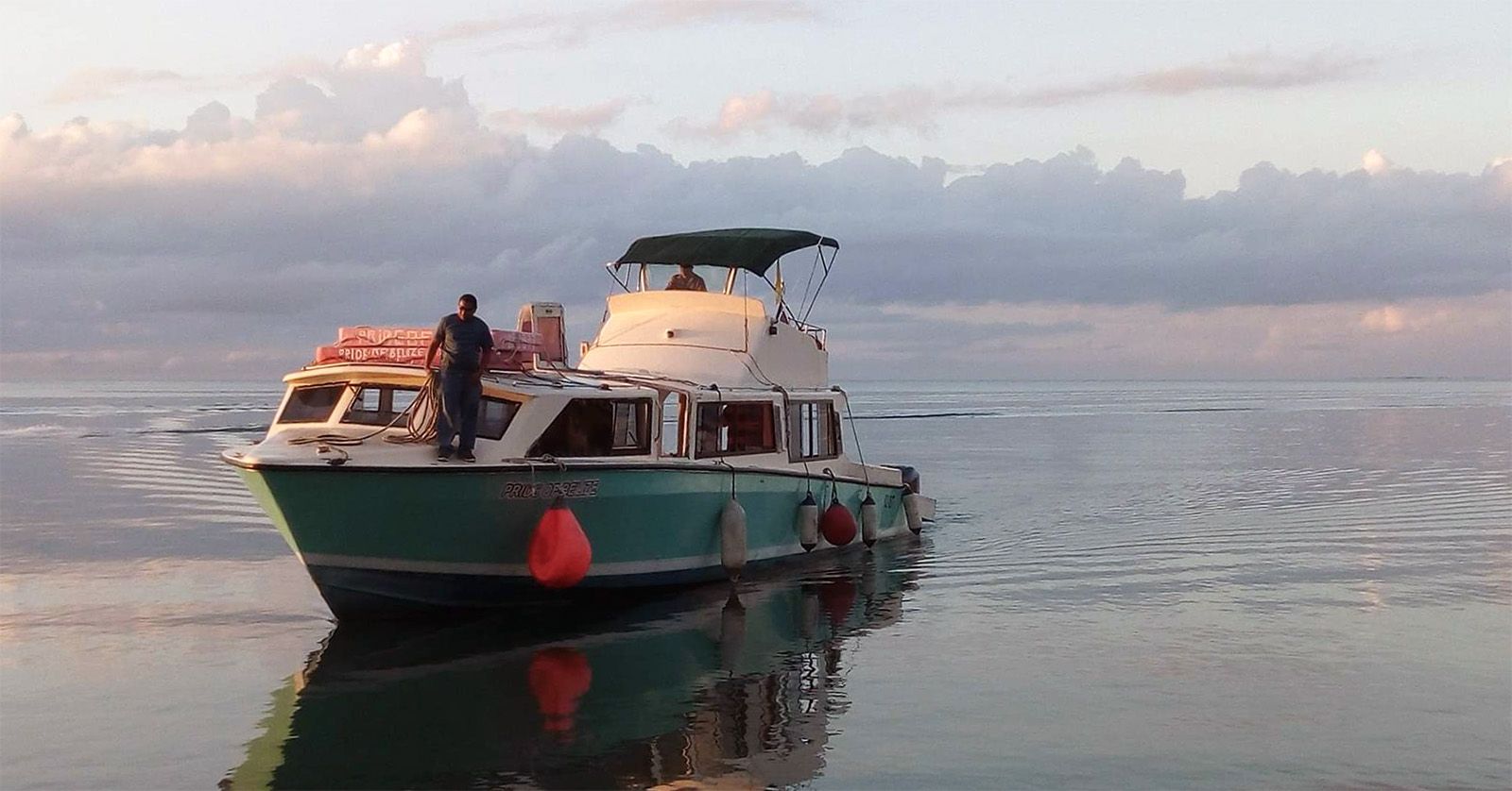 medium sized boat docking close to sunset