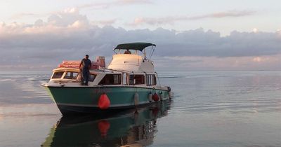 medium sized boat docking close to sunset