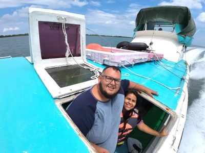 Two passengers of Pride of Belize by Gordo Soyacity two passengers on a medium sized boat vessel smiling