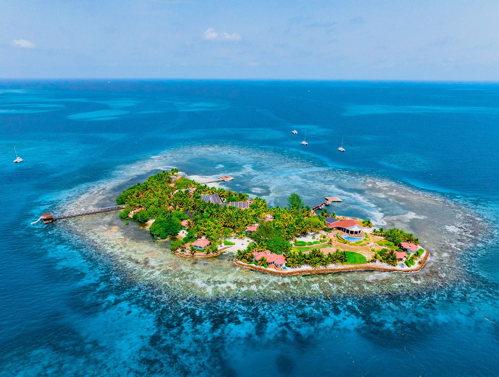 small island with buildings surrounded by docks and solar panels