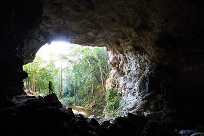 silhouette of girl inside cave