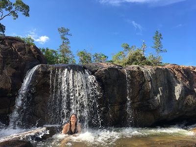 girl under small waterfall