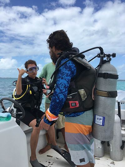 women getting ready to scuba dive on boat