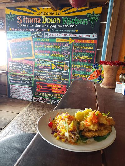 food on table with menu written on chalkboard in background