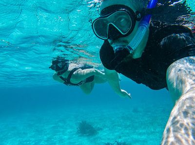 couple snorkleing side by side