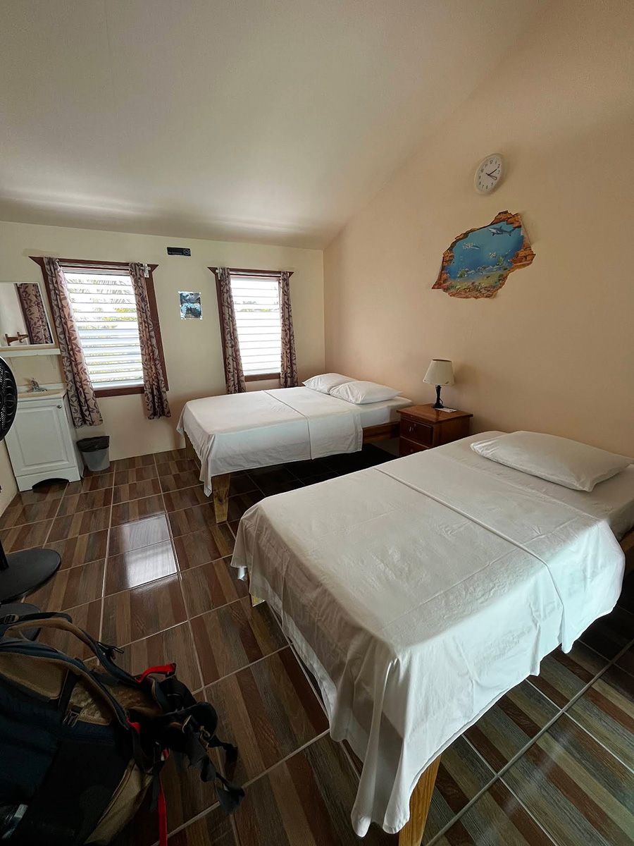 two beds in a cream colored room