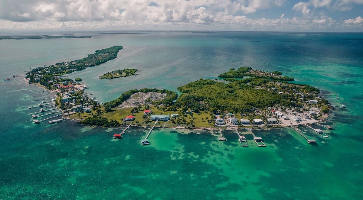 aerial of large island with docks around it