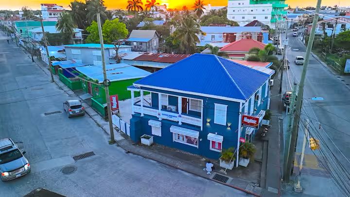 aerial of blue building with sunset in background