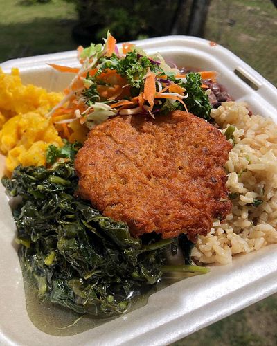 Vegetarian dish at Nutrilicious Corner in Belmopan vegetarian plate with greens, faux meat, rice and vegetables