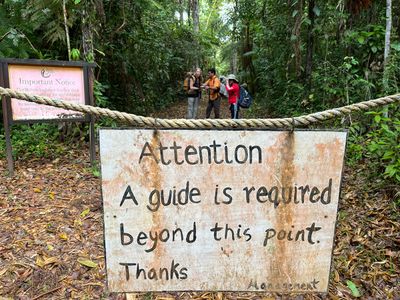 Hiking guide sign at Victoria Peak attention sign for guide requirement on rope
