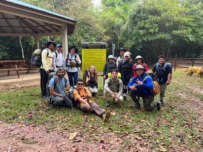 group shot of hikers in front of sign
