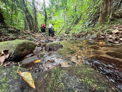 two hikers at river stream