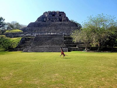 girl doing cartwheel in front of mayan ruin
