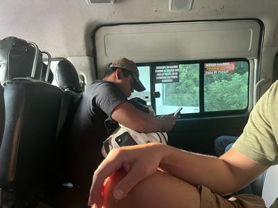 Interior of colectivo mini van man texting inside van